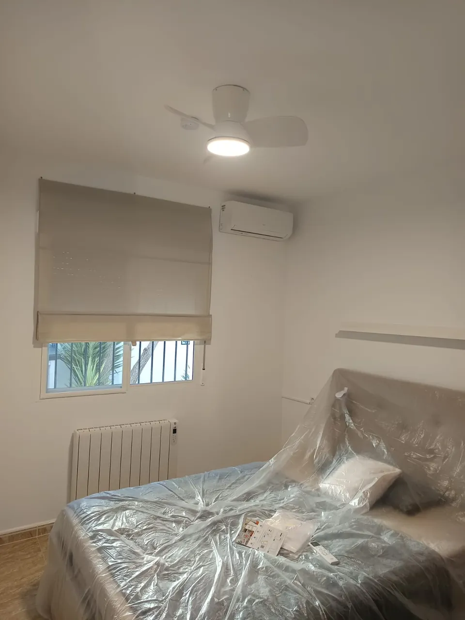 Instalación de aire acondicionado con el mobiliario protegido durante el montaje.